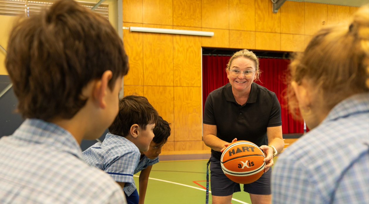 Teacher holding a ball. 