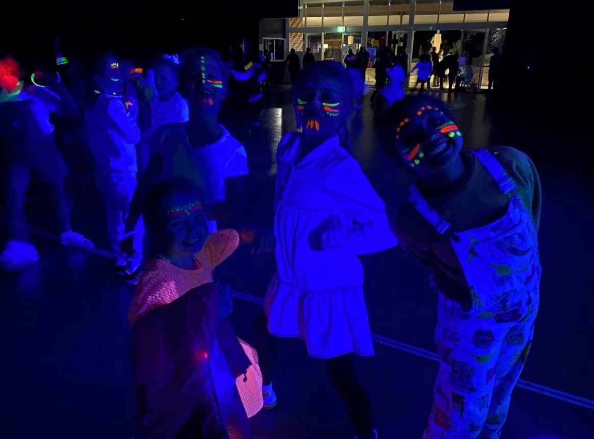 Students having fun at the STEM disco with fluro face painting
